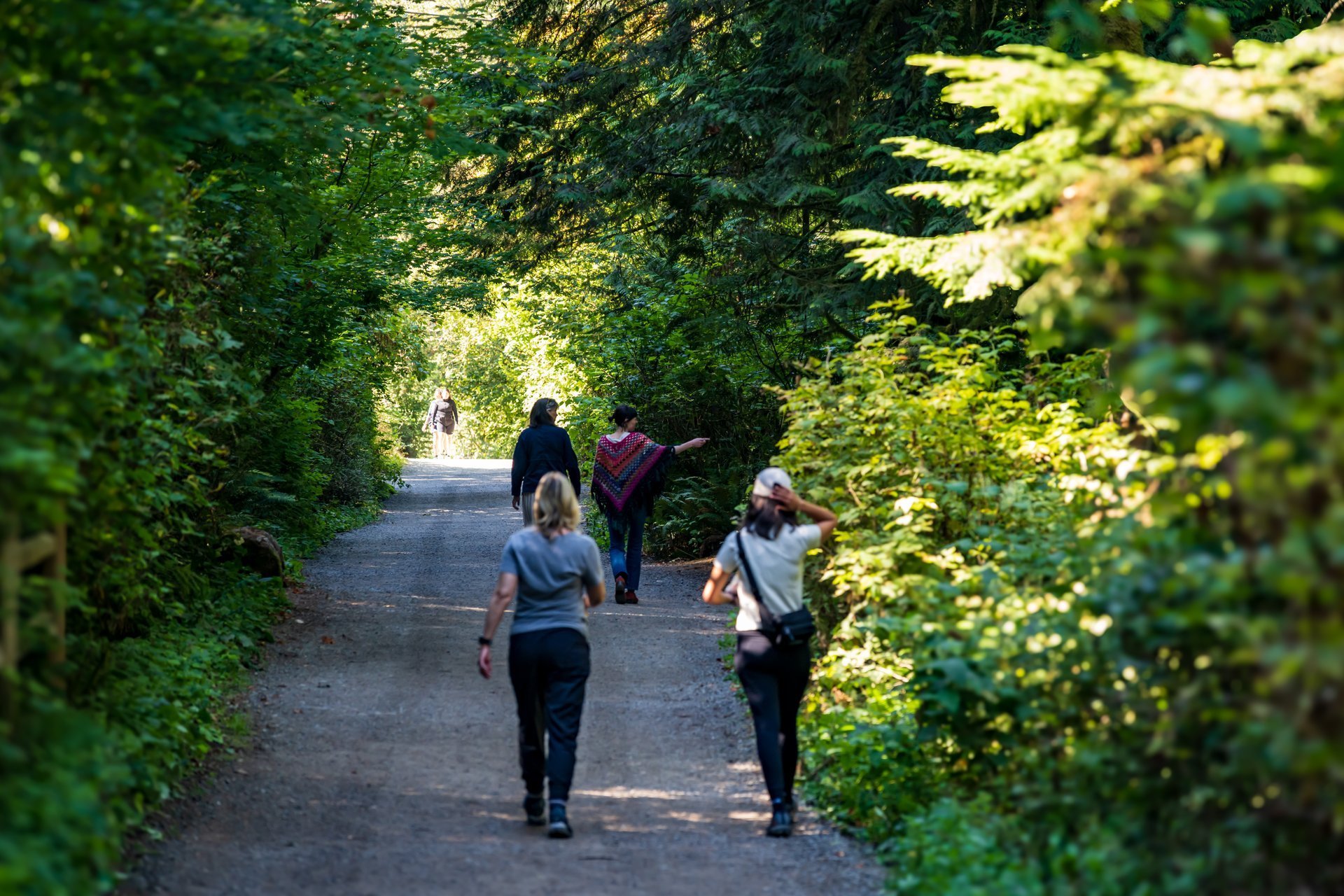 Women enjoy the lush green views along the Snoqualmie Falls hiking trail